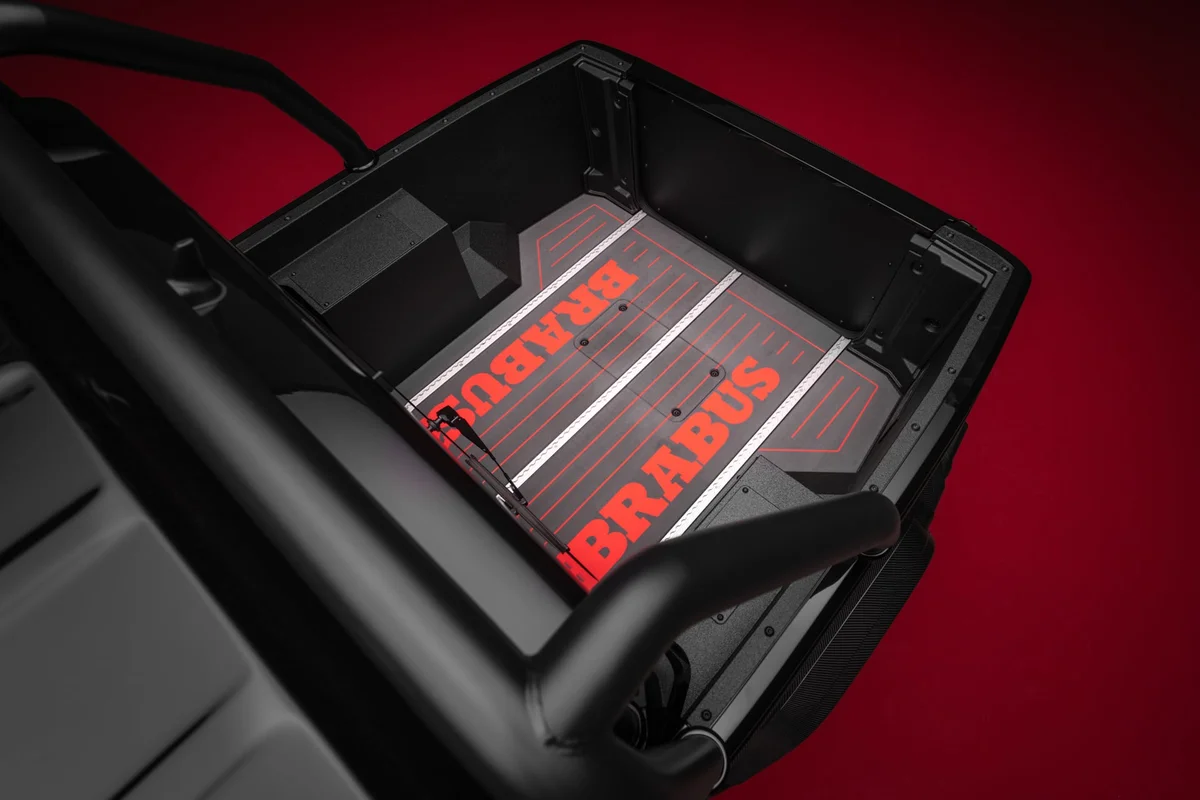 검은 카본 옆벽과 붉은 BRABUS 글자가 새겨진 티크 바닥의 적재함 내부