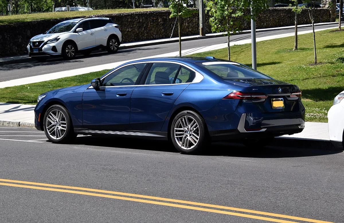 수입차 보증기간 기산 시점 설명용 도로에 서 있는 파란색 BMW 5시리즈(G60)의 뒤쪽 옆모습