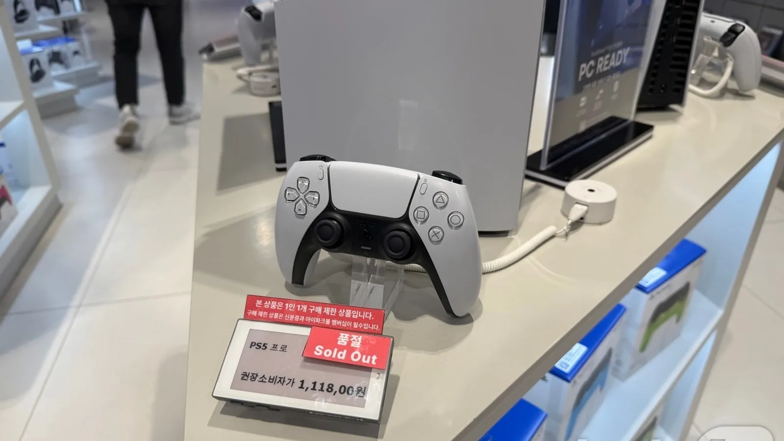 매장에 진열된 PS5 프로 본체와 듀얼센스 컨트롤러, 그 앞에 놓인 '품절 Sold Out' 안내판과 권장소비자가 1,118,000원이 적힌 가격표